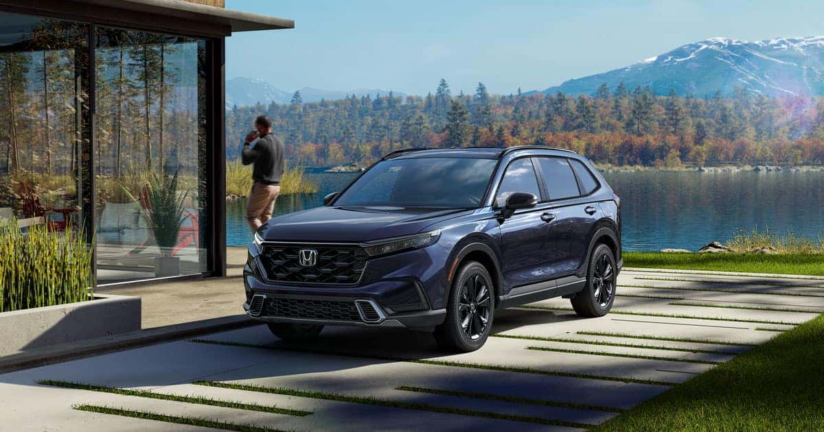 A 2026 Honda CR-V parked in the driveway of a lakehouse.