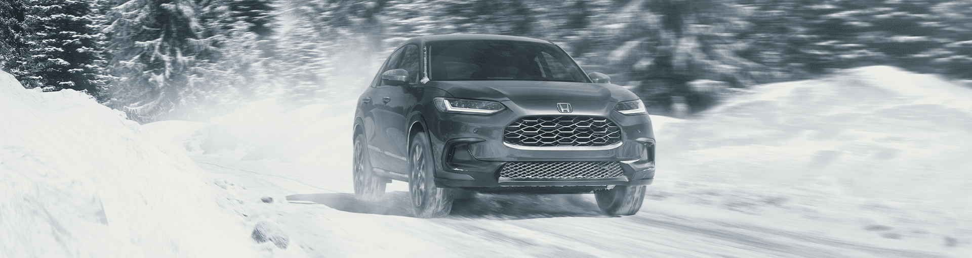 A Honda HR-V driving on a snowy road