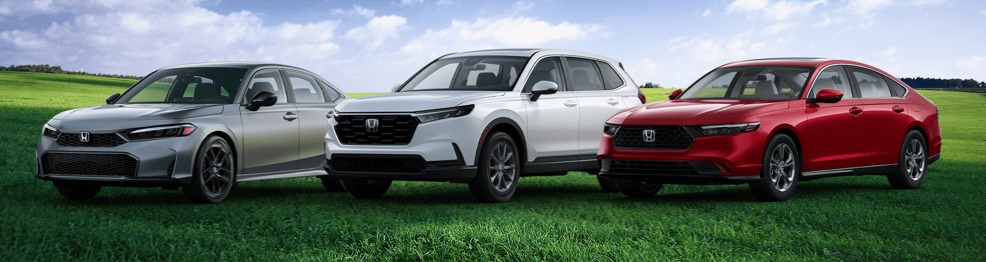 The 2026 Honda hybrid lineup sits side by side on a field of grass, featuring the new CR-V, the accord, and the civic