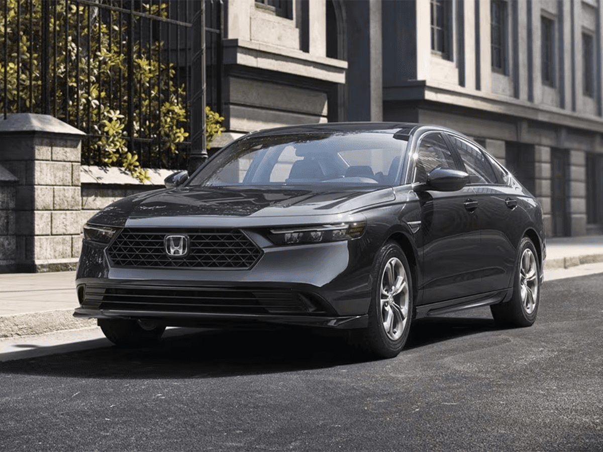 The new 2026 Honda Accord sits parked alongside a city street curb.