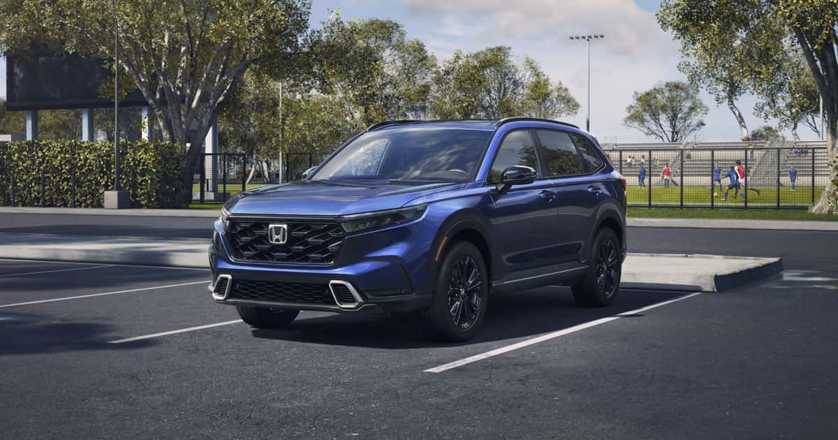 A blue Honda CR-V SUV parked at a soccer field.