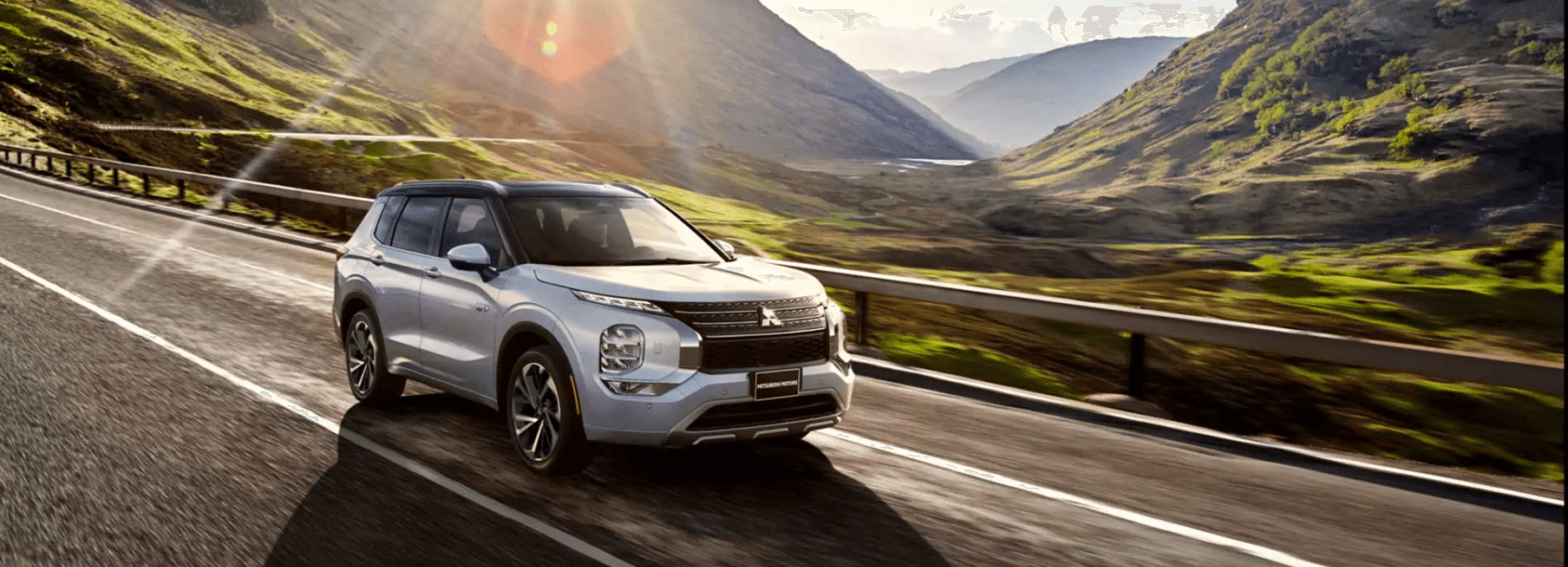 Mitsubishi vehicle on road in mountains