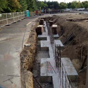 September 23, 2015 - Footing complete on the left side. Getting the rebar set up for the foundation walls.