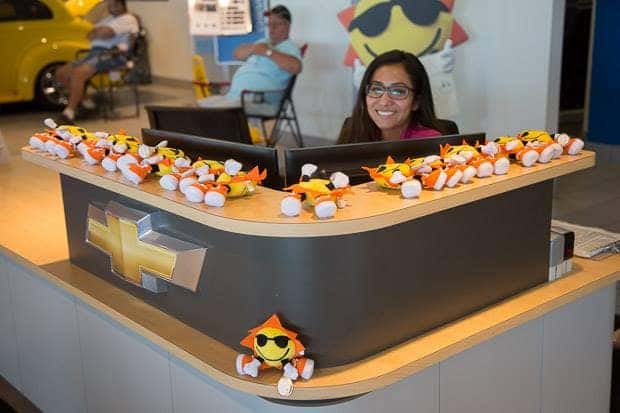 Sunrise Chevrolet dealership receptionist with Sunrise Chevrolet mascot toys