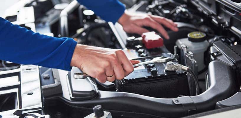 Man doing service check up on vehicle