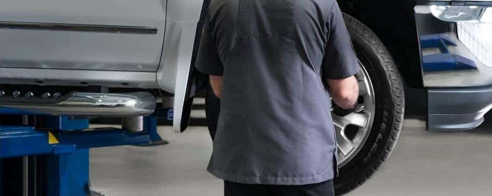 chevrolet tech changes tire on truck