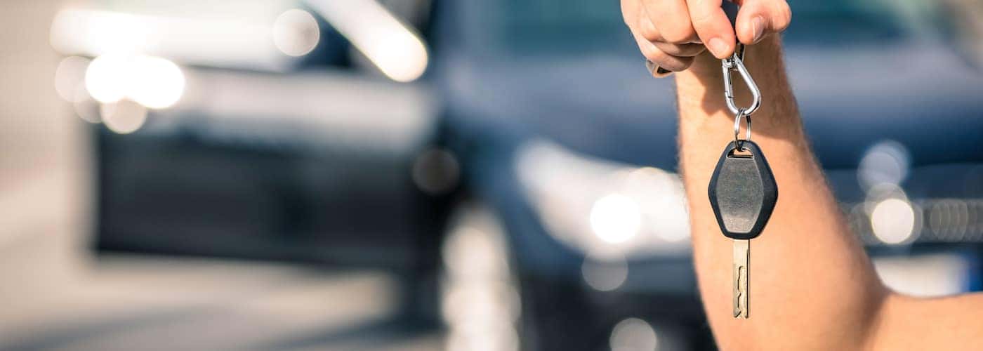 close up of cary keys with blurred car in background