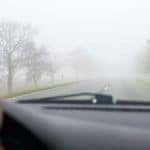 Car driving in fog
