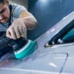 man polishes car