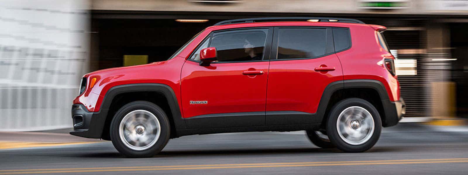 Red 2016 Jeep Renegade Driving down the street