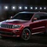 A dark red 2017 Jeep Cherokee is ready for a Jeep lease and is parked in a dark warehouse in Colorado Springs, CO.
