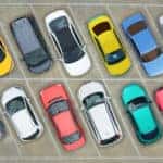 Aerial view of colorful vehicles parked in rows