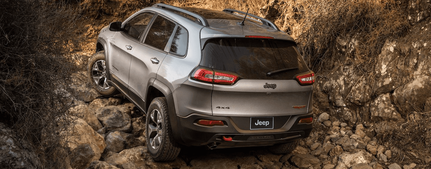 Silver 2017 Jeep Cherokee Trailhawk driving on a mountain trail in Colorado Springs CO.