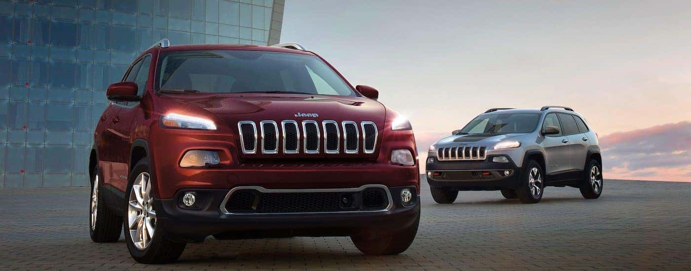 Two 2018 Jeep Cherokee s parked on side of building in Colorado Springs CO.