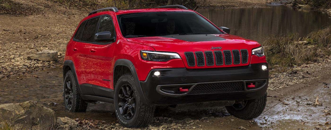 2018 Red Jeep Cherokee off roading on rocks in the desert in Colorado Springs CO.