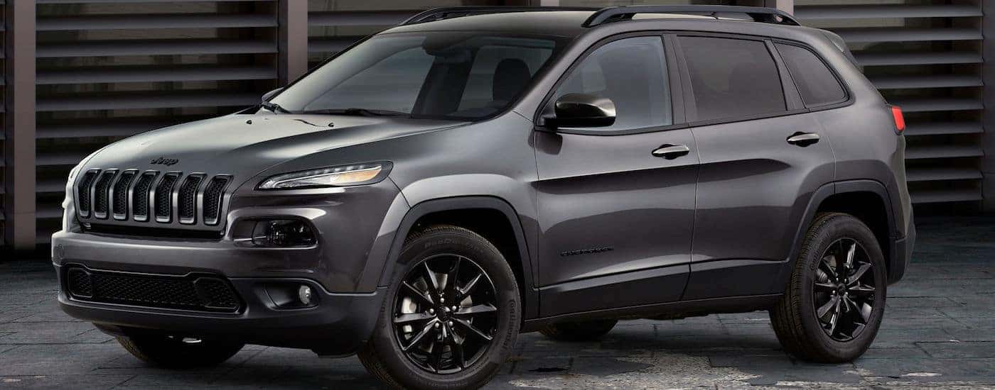 Grey 2018 Jeep Cherokee parked in front of old building in Colorado Springs CO.