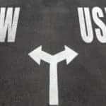 Pavement with the words "New" and "Used" written in white and arrows pointing toward each word