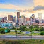 Streets and bridges in front of tall Denver buildings