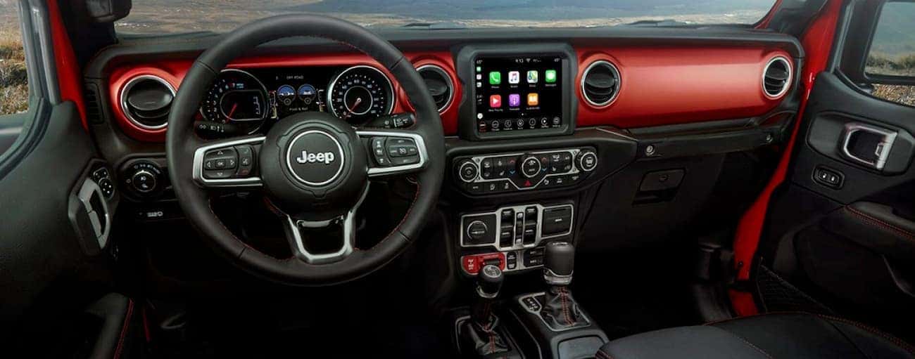 The black and red interior of a 2020 Jeep Gladiator is shown.