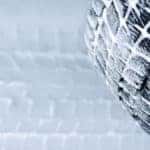 A closeup of a winter tire with snow