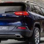 A blue 2015 Jeep Cherokee in the mountains