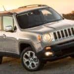 A silver 2018 Jeep Renegade, popular among used cars in Colorado Springs, CO, is parked on a road.