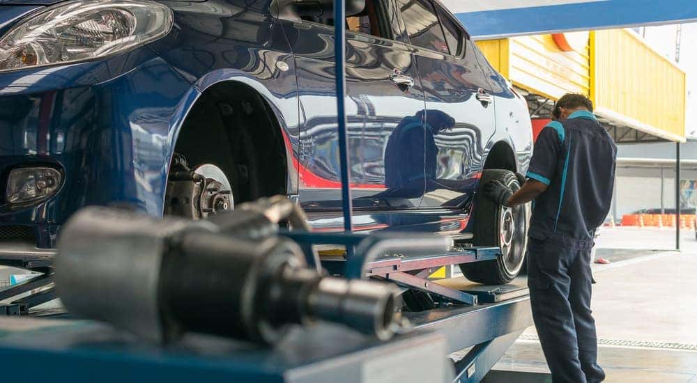 A mechanic in Colorado Springs, CO is working on a vehicle.