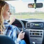 A teenage girl is driving alone for the first time because she has a solid understanding of teen driving laws in Colorado.