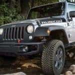 A grey 2018 Jeep Wrangler is off-roading near Colorado Springs, CO.