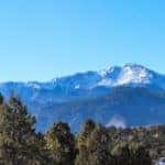 Pikes Peak is shown with blue skies.