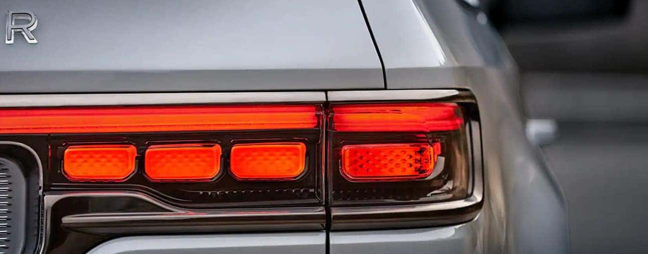 The taillight of a silver 2022 Wagoneer is shown in closeup.