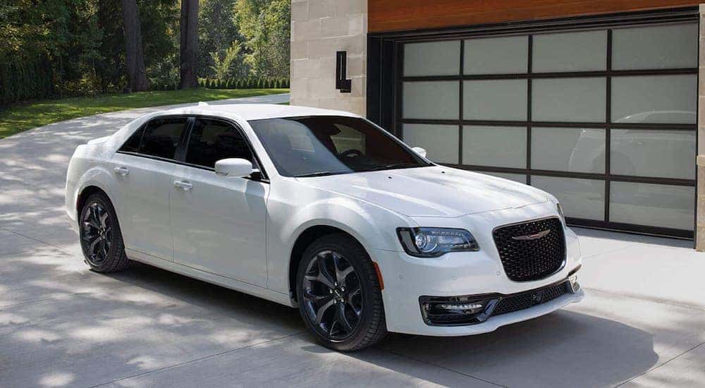A white 2021 Chrysler 300 is parked in a driveway.