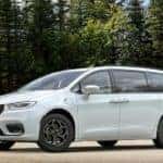 A white 2020 used Chrysler Pacifica Hybrid Limited S is shown parked near trees.
