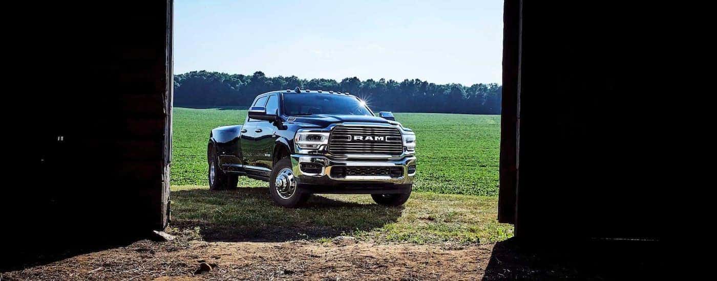 A black 2021 Ram 3500 is shown through open barn doors.