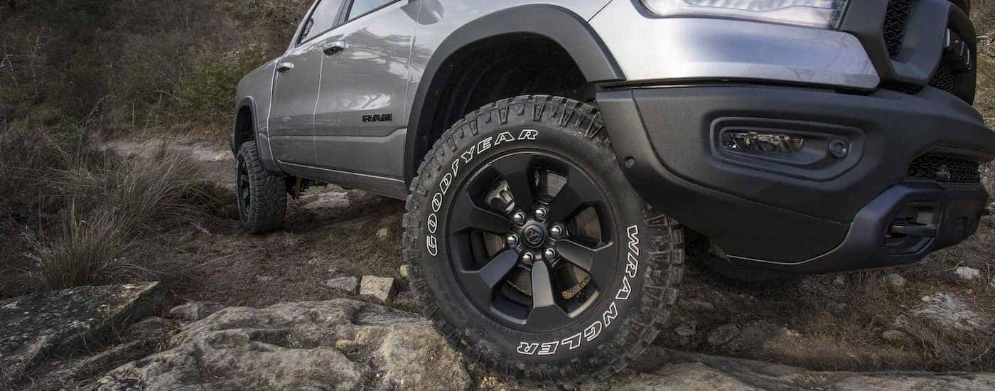 A close up shows the black wheel and tire on a silver 2022 Ram 1500.