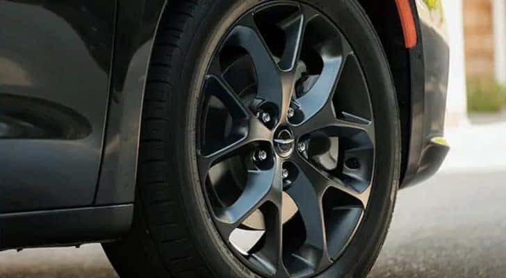 A close up shows the wheel and tire on a 2021 Chrysler Pacifica.
