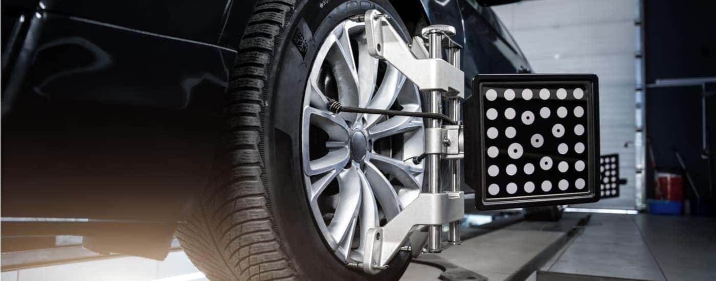 A car is shown getting a tire alignment.