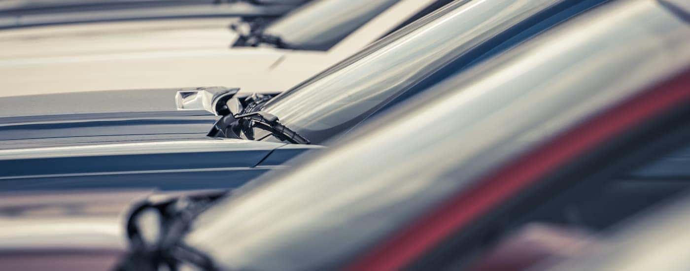A row or cars are shown parked at a Certified Pre-Owned car dealer.