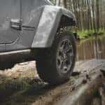A close up shows the wheel-well and tire on a silver 2021 Jeep Wrangler Unlimited.