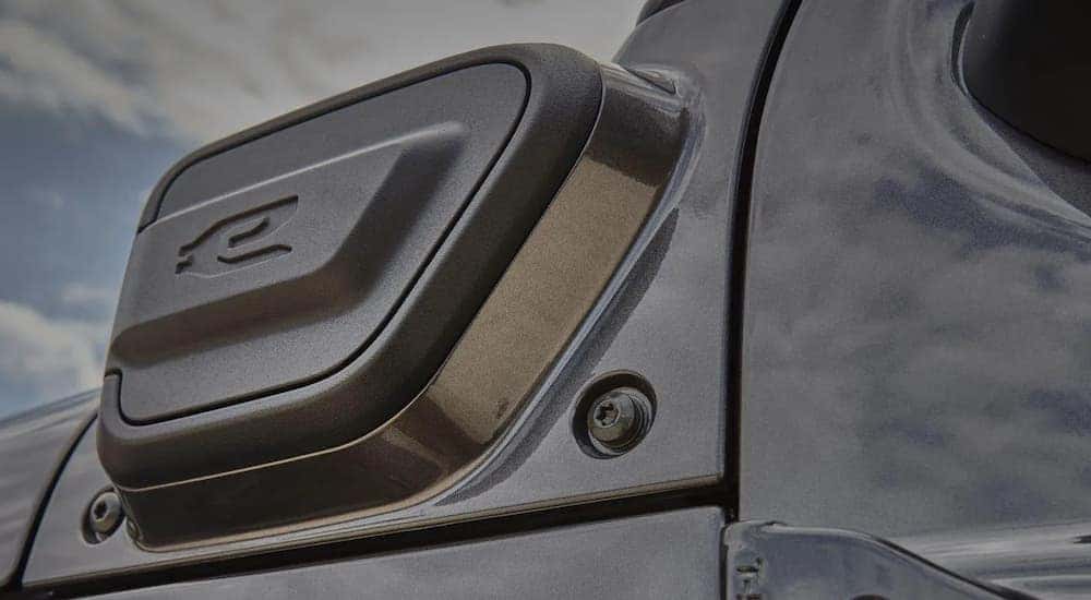 A close up shows the charge port on a grey 2022 Jeep Wrangler 4xe.