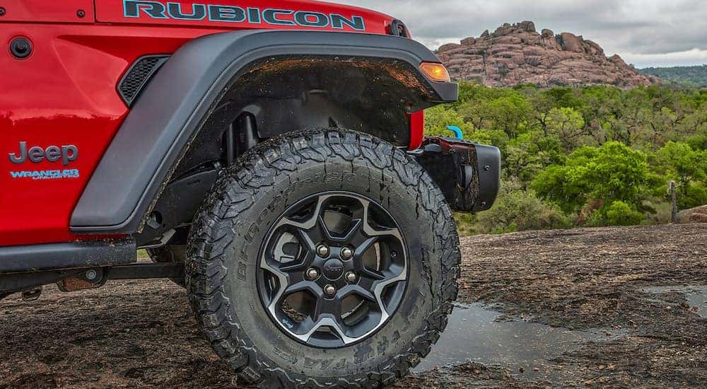 A close up shows the wheel on a red 2022 Jeep Wrangler 4xe.