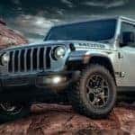 A silver 2022 Jeep Wrangler Unlimited MOAB is shown from the front while off-road.