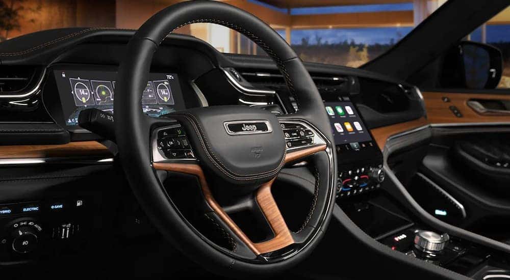 A close up shows the black and tan interior in a 2023 Jeep Grand Cherokee Summit Reserve 4xe.