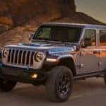 A grey 2022 Jeep Wrangler 4xe is shown from the front at an angle.