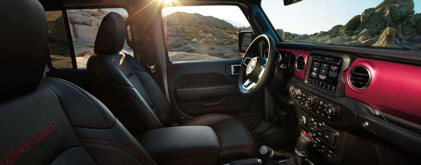 The black and red interior of a 2022 Jeep Gladiator is shown at a Jeep Gladiator dealer.