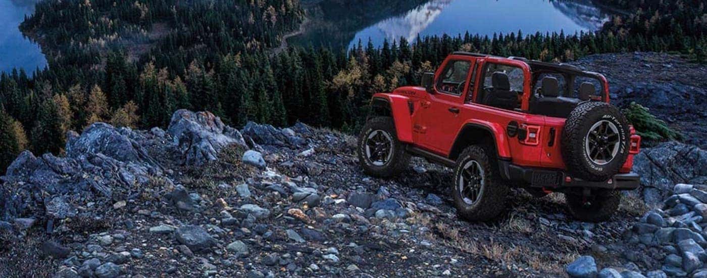 A red 2020 Jeep Wrangler Rubicon is shown from the rear at an angle.