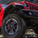 A red 2022 Jeep Wrangler Unlimited is shown from the front in close up.