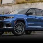 A blue 2022 Jeep Grand Cherokee is shown from the front at an angle after leavign a dealer that has a used Jeep Grand Cherokee for sale in Colorado Springs.