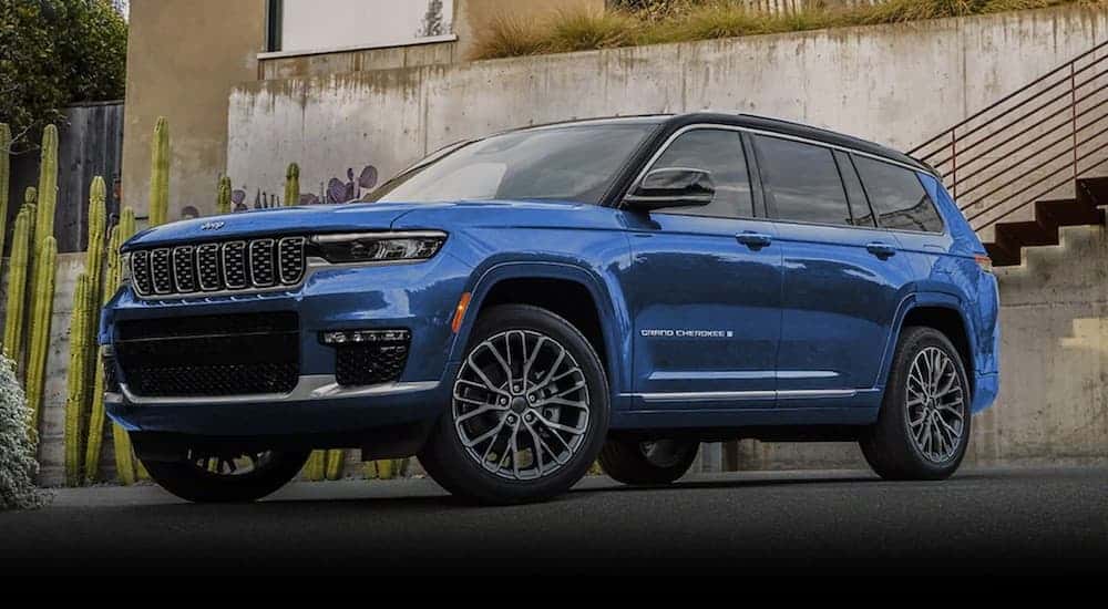 A blue 2022 Jeep Grand Cherokee is shown from the front at an angle after leaving a dealer that has a used Jeep Grand Cherokee for sale in Colorado Springs.