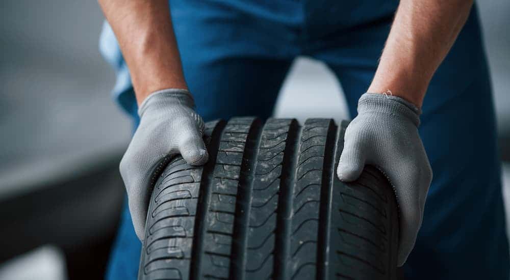 A mechanic is shown inspecting a tire at a Tire center in Colorado Springs.